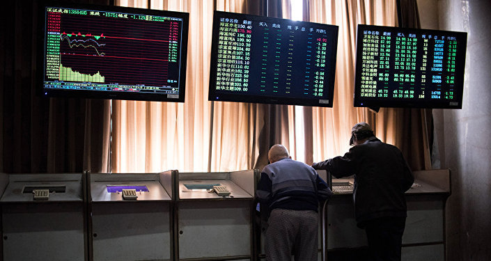 Chinese investors look at prices of shares and the Shanghai Composite Index at a stock brokerage house